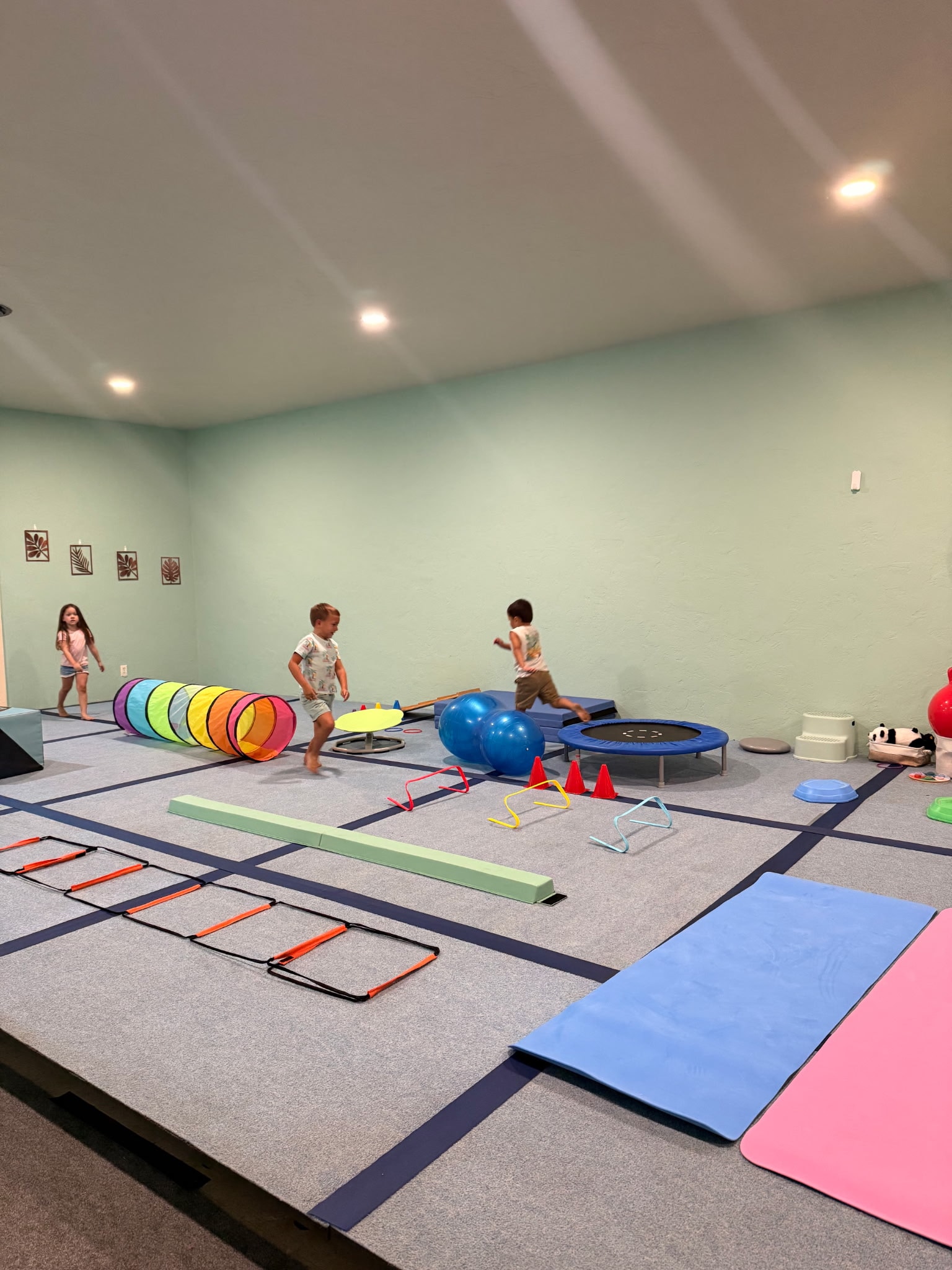 Children playing on an indoor obstacle course
