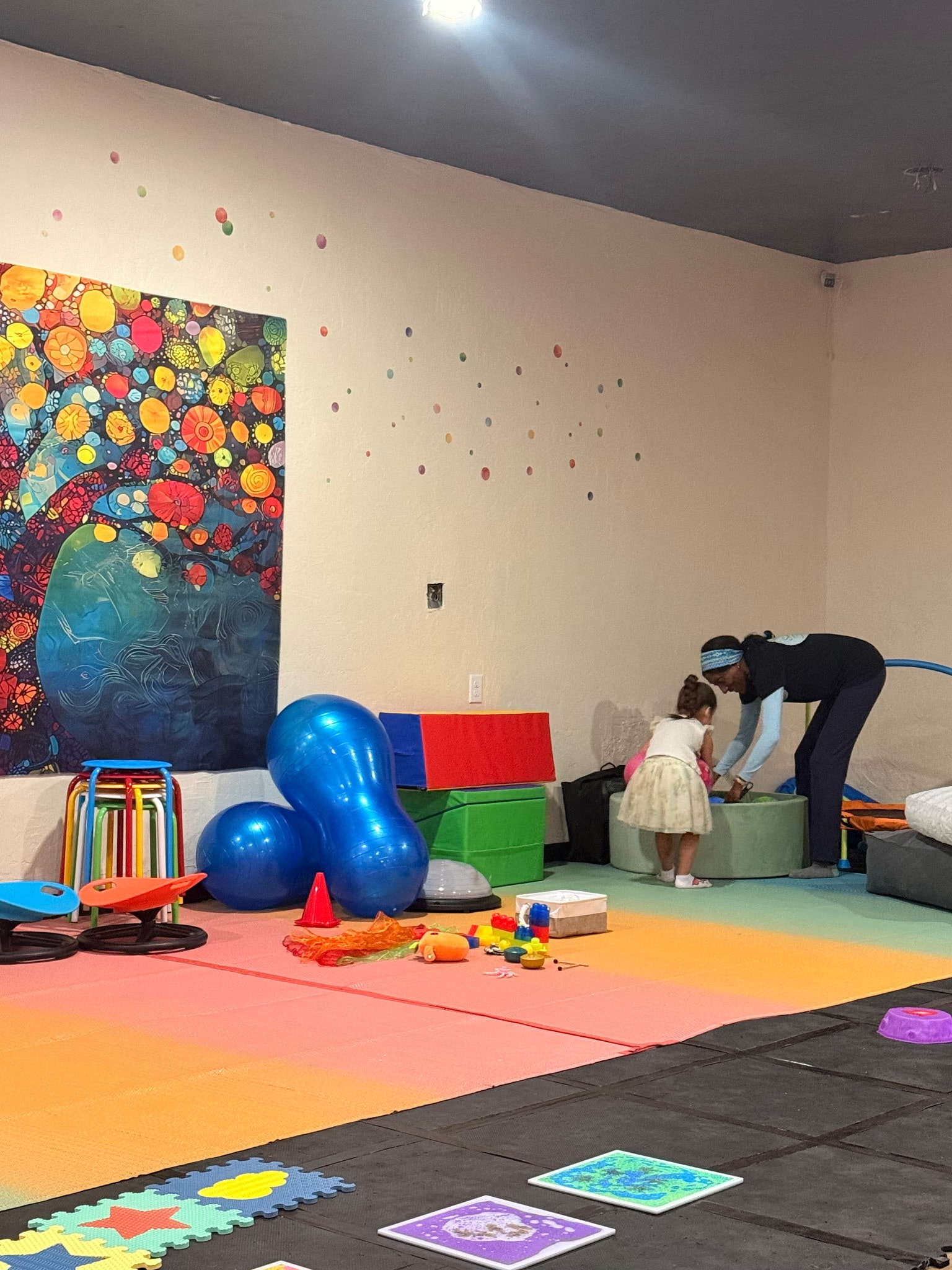 Adult helping a child play in a sensory gym
