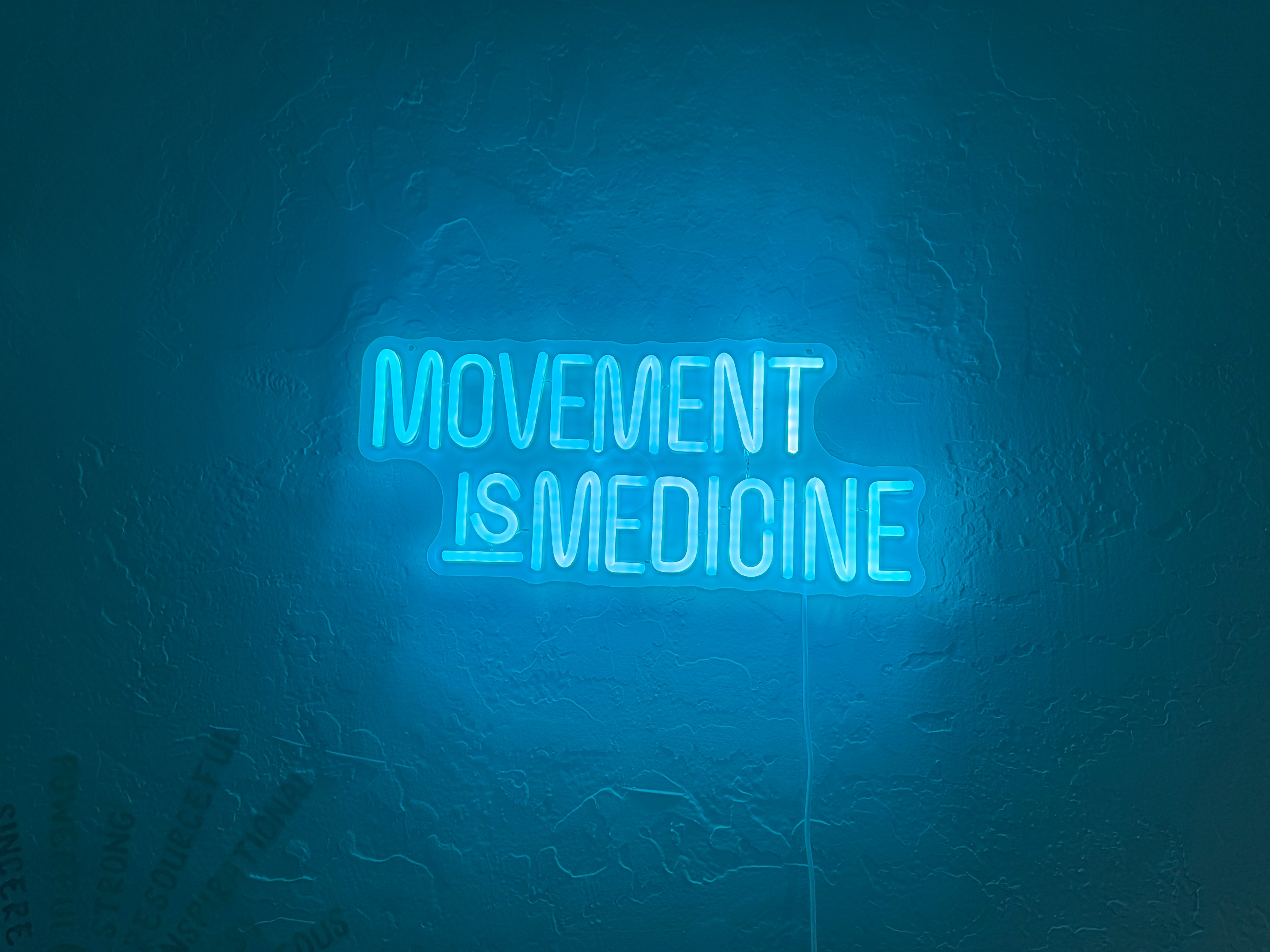 Glowing Movement Is Medicine sign at Sweet Peas PPP in Porterville, California